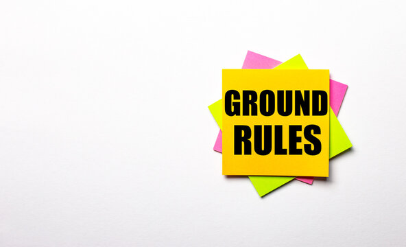 On a light background - bright multicolored stickers with the text GROUND RULES. Copy space