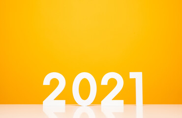 Happy new year 2021 mockup on white table and yellow background color. Celebrate with new year theme concept.
