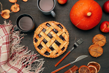 Thanksgiving pie and pumpkin on black background