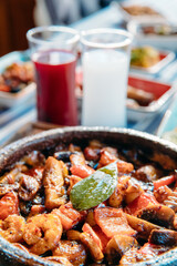 Seafoods, grilled meat, meze, herbs, fish, raki, ouzo, appetizers and salads in Greek or Turkish Fish Restaurant on the table for dinner or lunch at the beach from Greece or Turkey.