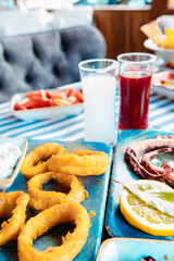Seafoods, grilled meat, meze, herbs, fish, raki, ouzo, appetizers and salads in Greek or Turkish Fish Restaurant on the table for dinner or lunch at the beach from Greece or Turkey.