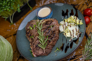 grilled t-bone steak on blue plate