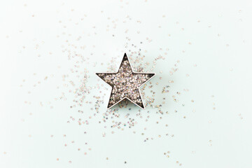 Star with sparkles and shapes for gingerbread on blue pastel background. Christmas, winter, new year concept. Minimal style. Flat lay, top view, copy space.
