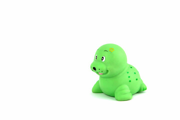 Green rubber seal or fur seal for playing in the bathroom by a child on a white background. Water toy. Child development