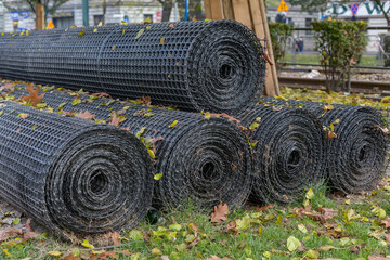  Rolls of black plastic geogrid prepared for reinforcement the roadbed.