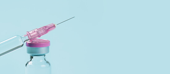 one glass syringe with a needle on blue . copy space close up view. Medication safe consumption and...