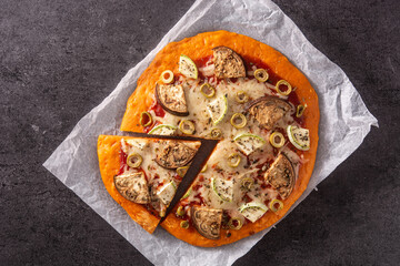 Autumn pumpkin pizza with vegetables on blackboard background. Top view