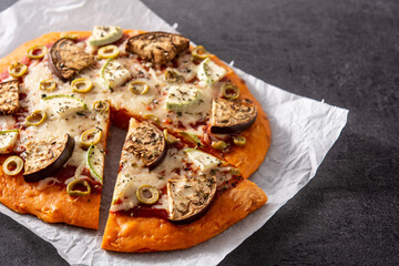 Autumn pumpkin pizza with vegetables on blackboard background. Copy space