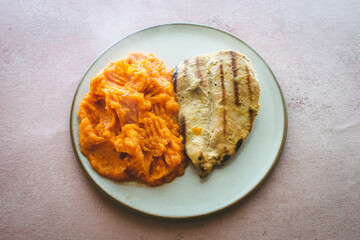 delicious grilled chicken dish with pumpkin puree, presented ready to eat

