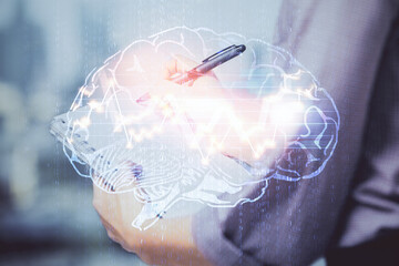 Multi exposure of woman's writing hand on background with brain hologram. Concept of brainstorming.