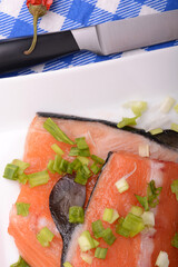 Food concept: red salmon fish and cabbage with red chilli pepper with greens. Healthy food cooking.