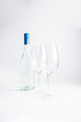 Wine bottle and two wine glasses. Wine bottle against a white background