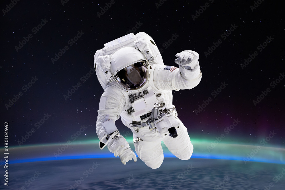 Wall mural composite image of astronaut floating in space, earth planet in the background - elements of this im