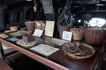 Old wooden ship pantry with food and chest