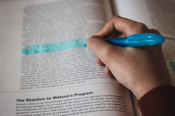 Student doing homework. underline. words. write. student doing his doctoral thesis. graduate. homework. university. school.
