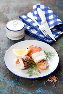 Baked congrio or king klip fish on a plate, selective focus