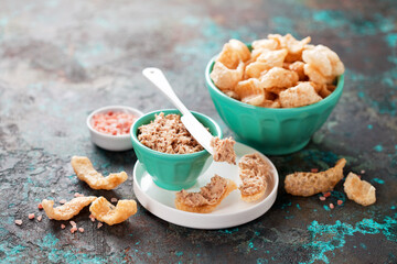 Pork rinds with sardine fish rillette, selective focus