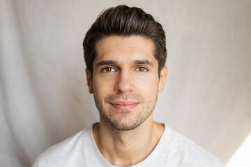 Portrait of a young handsome latin man with a slight smile and beautiful skin and hair