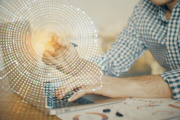 Man typing on keyboard background with brain hologram. Concept of big Data.