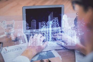 High tech city drawing with businessman working on computer on background. Smartcity concept. Double exposure.