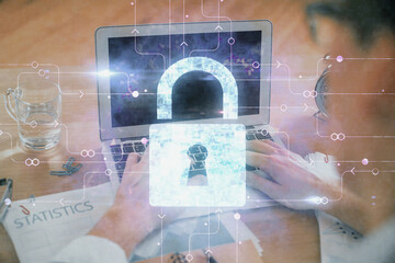 Double exposure of lock icon with man working on computer on background. Concept of network security.