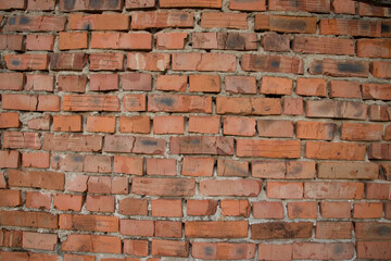Old brick wall with scratches, cracks, dust, crevices, roughness. 