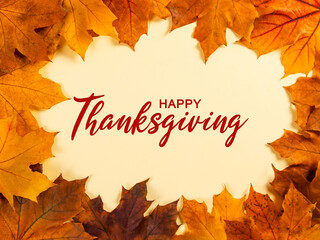 Thanksgiving greetings. Dry yellow leaves and frame on yellow background, top view. Kaligraphic capital inscription.