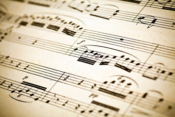 Fototapeta premium Vintage yellow paper sheet with musical notes.