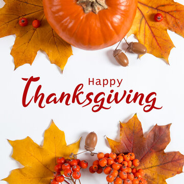 Thanksgiving greetings. Dry yellow leaves, pumpkins, berries on a white background, top view. Kaligraphic capital inscription.