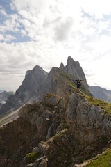 Obraz premium Hiking on the dramatic mountain ridge of Seceda in South Tyrol's Dolomites, Northern Italy