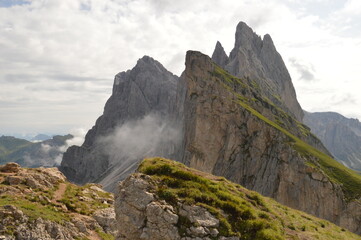Fototapeta premium Hiking on the dramatic mountain ridge of Seceda in South Tyrol's Dolomites, Northern Italy