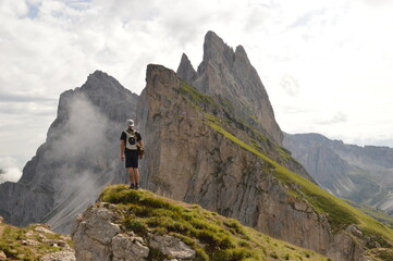 Hiking on the dramatic mountain ridge of Seceda in South Tyrol's Dolomites, Northern Italy