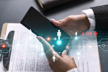 Businesswoman using smart phone in office. Social media icon hologram. Business network concept. Double exposure.