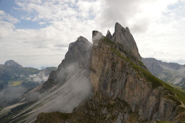 Fototapeta na wymiar Hiking on the dramatic mountain ridge of Seceda in South Tyrol's Dolomites, Northern Italy