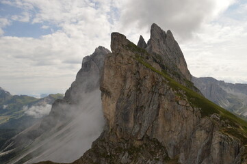 Fototapeta na wymiar Hiking on the dramatic mountain ridge of Seceda in South Tyrol's Dolomites, Northern Italy