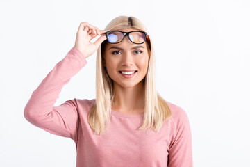 Smiling woman looking at camera while holding eyeglasses isolated on white