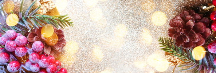 Christmas festive background. Festive Christmas decoration, new year garland, pine branch with ornaments close-up. Blurred bokeh background.