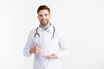 Front view of smiling ophthalmologist with thumb up, holding lenses container and plastic bottle...