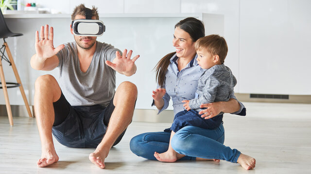 Mann mit VR-Brille ertastet virtuelles Wohnzimmer