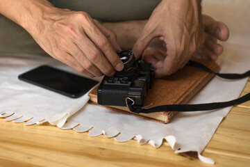 Man taking out the lens from camera.