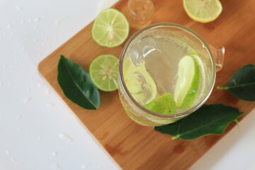 Health care, fitness, healthy nutrition diet concept. Fresh cool lemon infused water, detox drink, lemonade in a glass jug and a glass, Top View .
