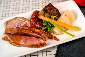 Sliced Peking duck with shiitake, vegetable and sesame pancake.