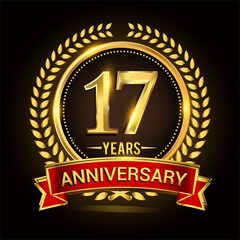 17th golden anniversary logo, with shiny ring and red ribbon, laurel wreath isolated on black background, vector design