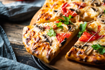 tasty juicy pizza on wooden background. lots of meat and cheese. Mushroom pizza. Pepperoni pizza. Mozzarella and tomato. Italian dish. Italian food.