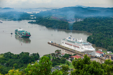 A Cruise Ship and Cargo Ship about to Transit Pedro Miguel Locks in the Panama Canal with the Bridge of the Americas in the Distance, Panama