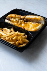 Take Away Philly Cheese Steak Sandwich with Melted Cheddar Cheese and Potatoes in Plastic Container Plate Package.