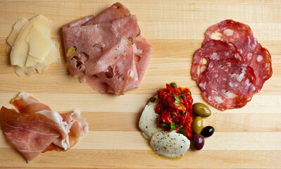 Charcuterie platter. Assortment on cured and salted deli meats and cheeses, pastrami, salami, prosciutto served with olives and dried fruits. Classic traditional party favorite.  