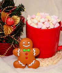 Gingerbread man Cookie with Red Cup Of Hot Chocolate With Marshmallow and New year tree On White Background.