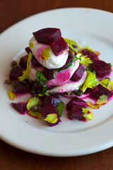 Beet salad. Classic Italian salad with beets, mozzarella, spinach, arugula, Parmesan cheese, olive oil, lemon juice, salt and pepper. A Fine dining restaurant classic.