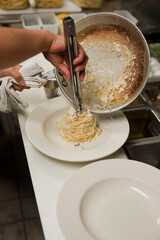 Spaghetti carbonara. Pasta with cured pork, cheese, egg, bacon, pepper and Italian parsley. Classic American or Italian restaurant favorite. Homemade pasta with butter sauce, meat and cheese.